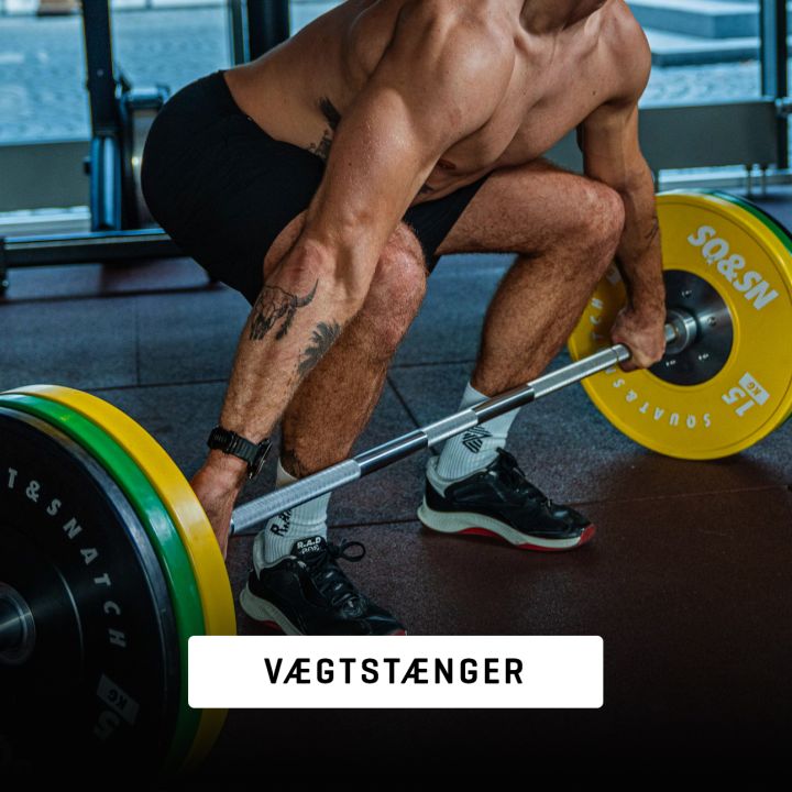 Vægtstænger til styrketræning og crossfit med skiver i et funktionelt gymmiljø